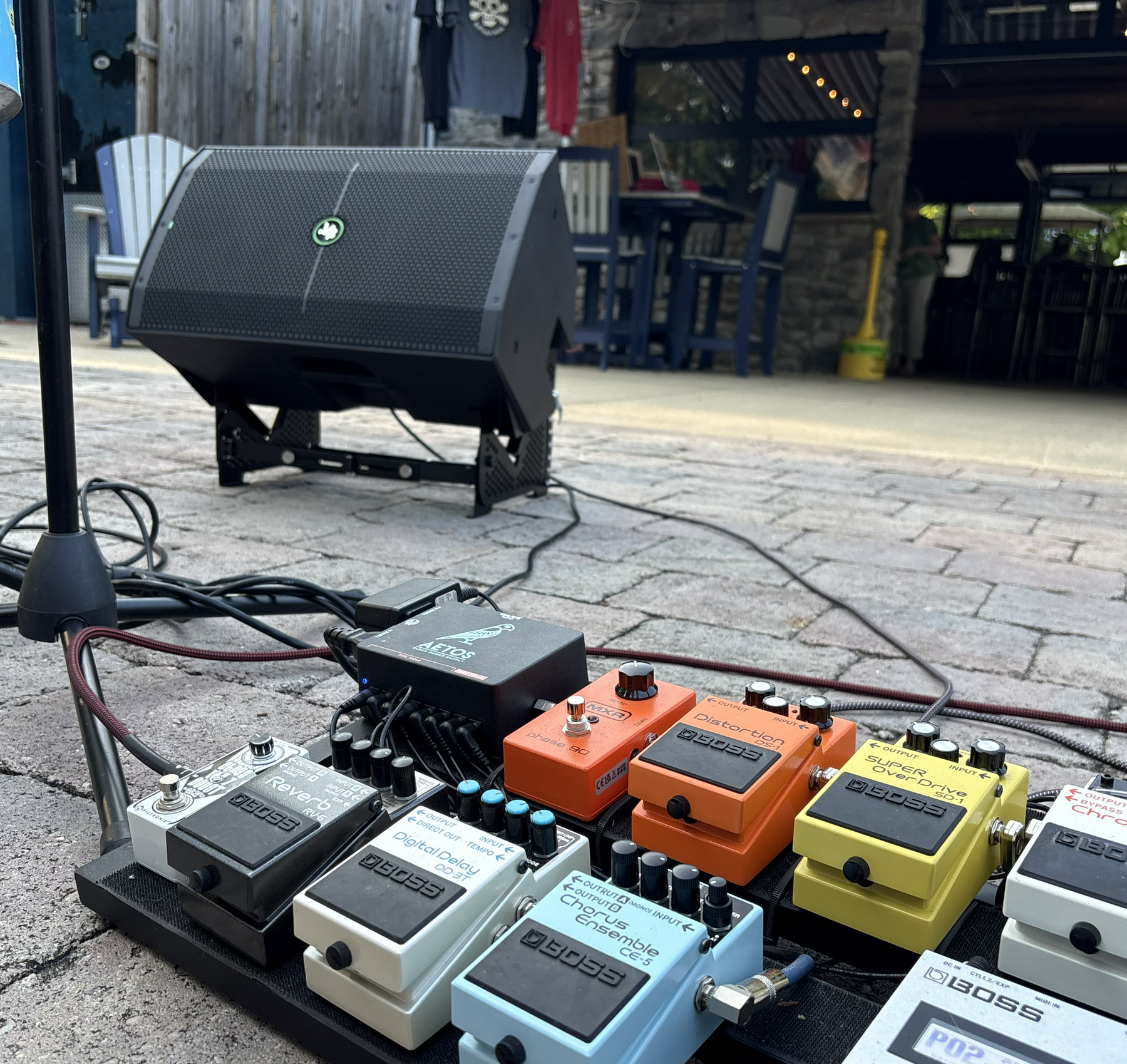AmpTiltor™ supporting a stage monitor near a pedalboard