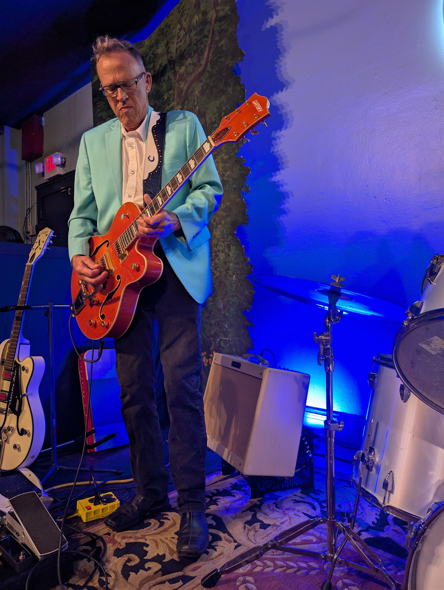 Musician performing with amplifier elevated on AmpTiltor™